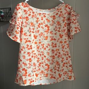 Cream colored blouse with orange floral pattern